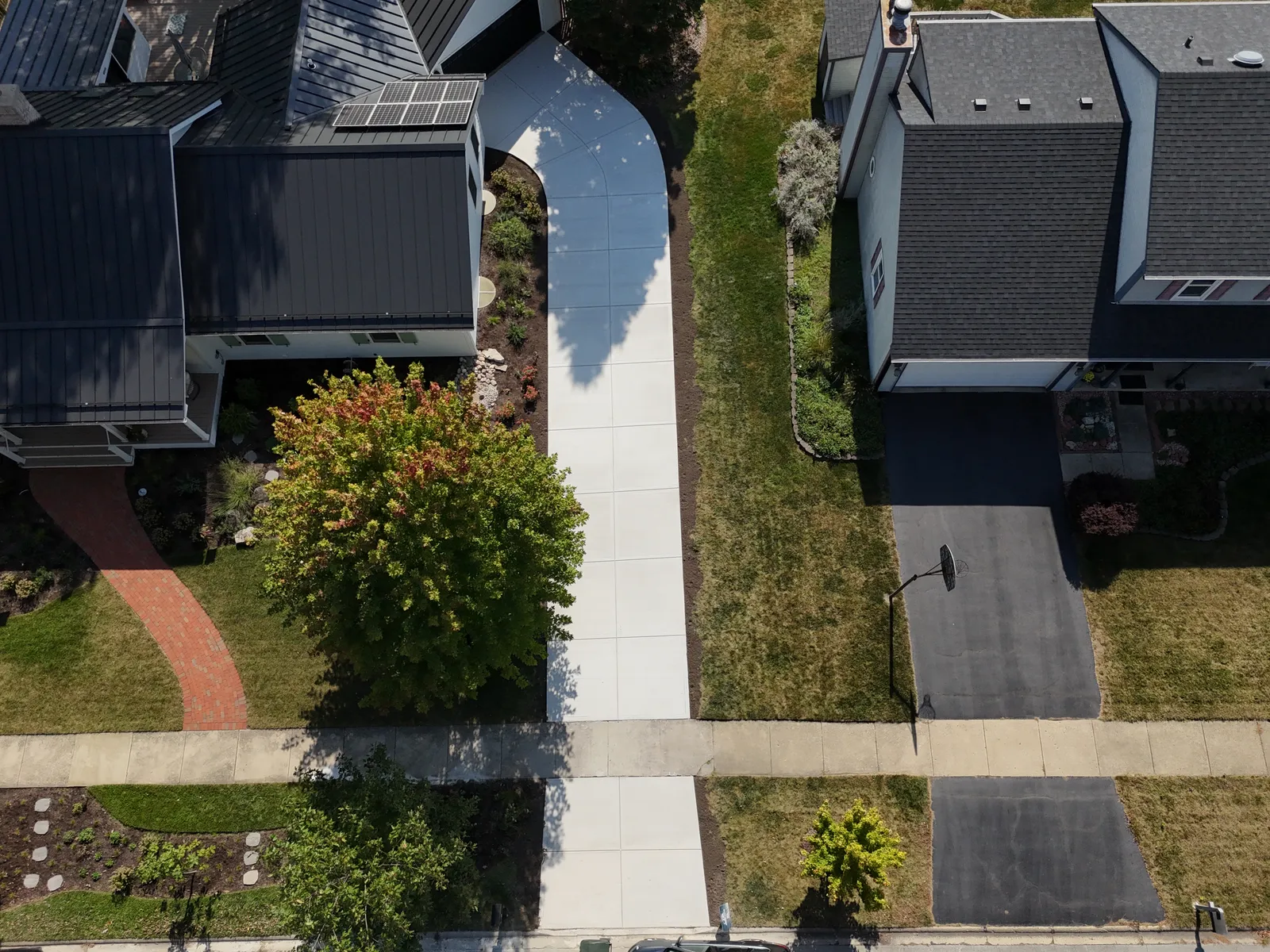Long concrete driveway pour — aerial drone view