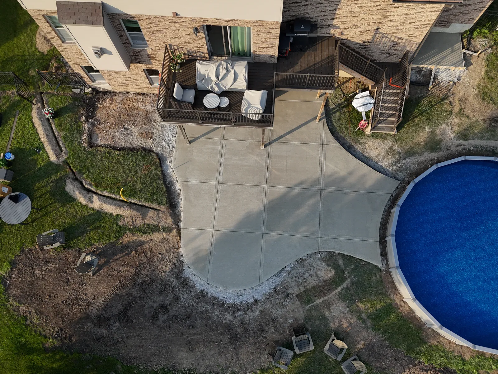 Freeform concrete patio at pool area — aerial drone view