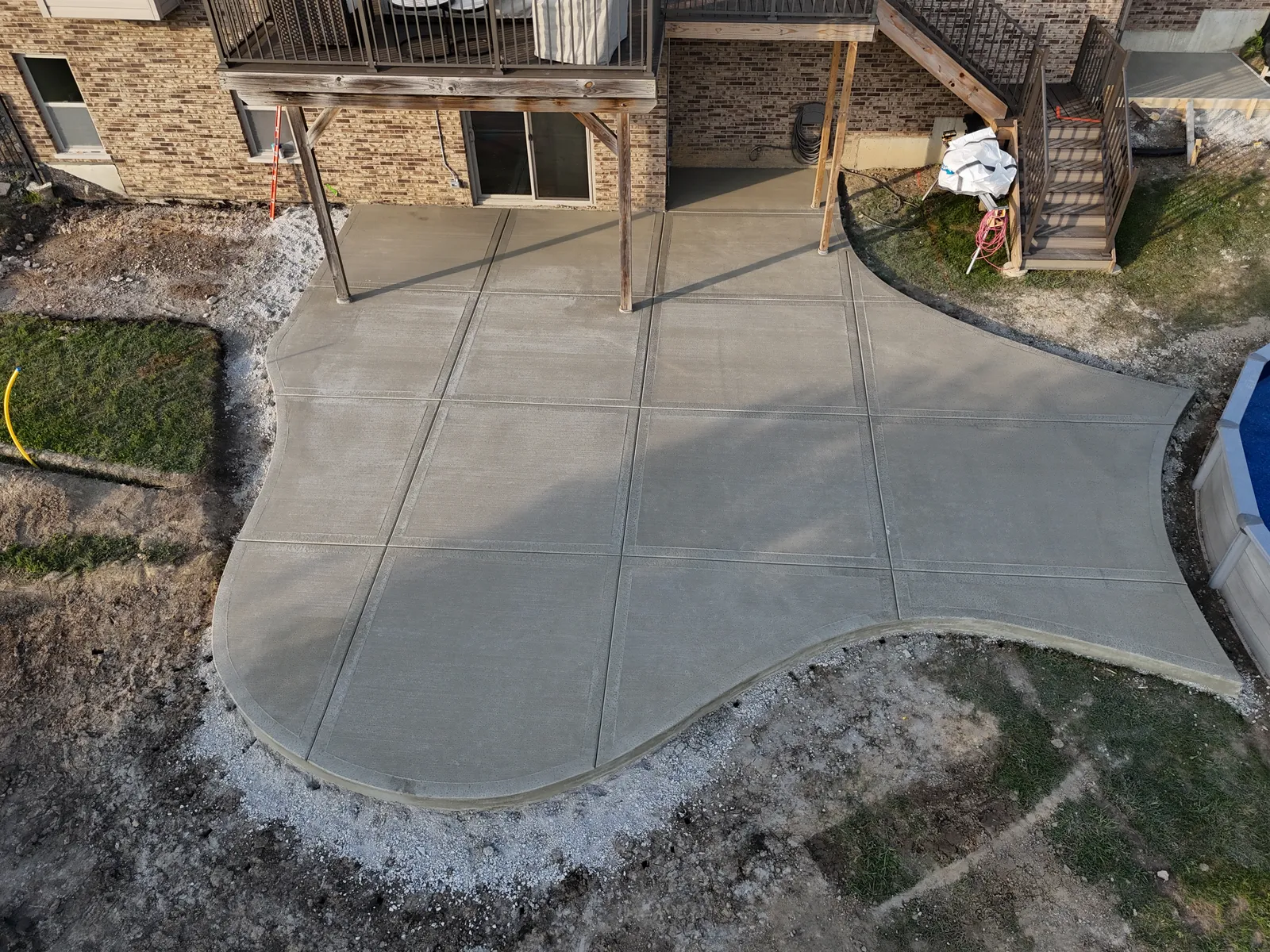 Freeform pool-area patio perspective showing saw-cut joints
