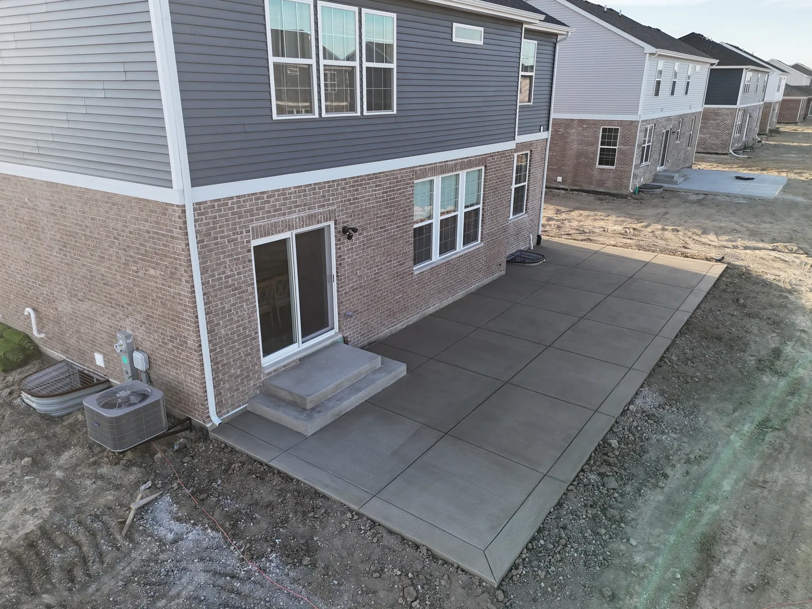 New-build concrete patio from low perspective
