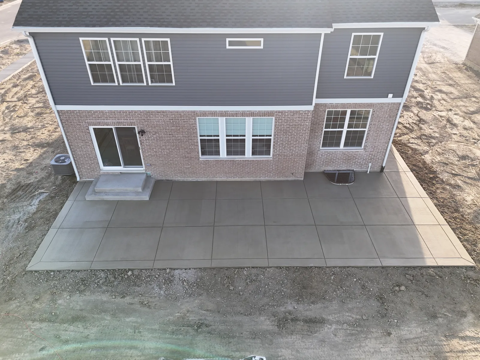 New construction concrete patio in golden hour light