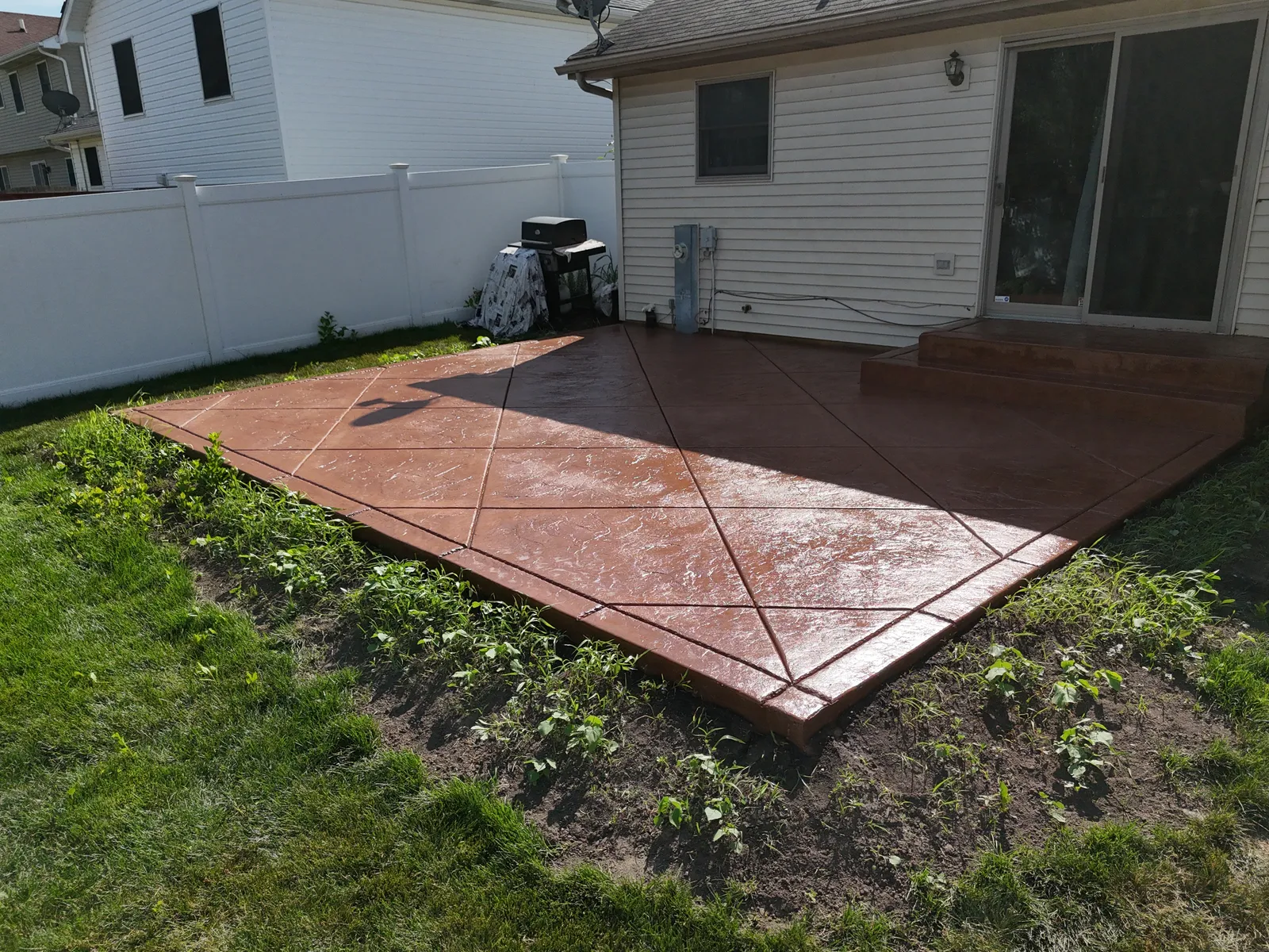 Bold terracotta stained concrete patio — aerial drone view
