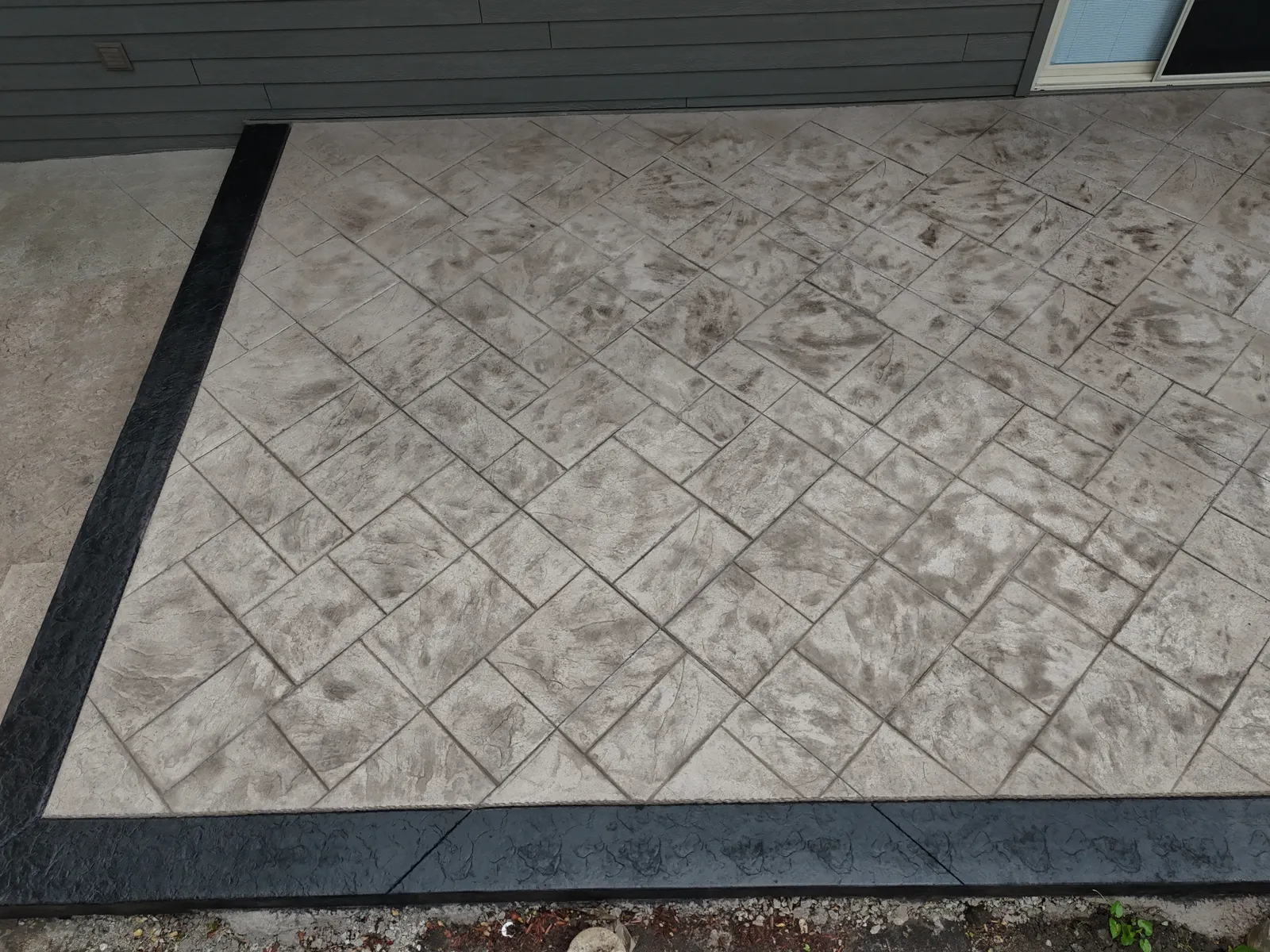 Herringbone stamped concrete texture close-up