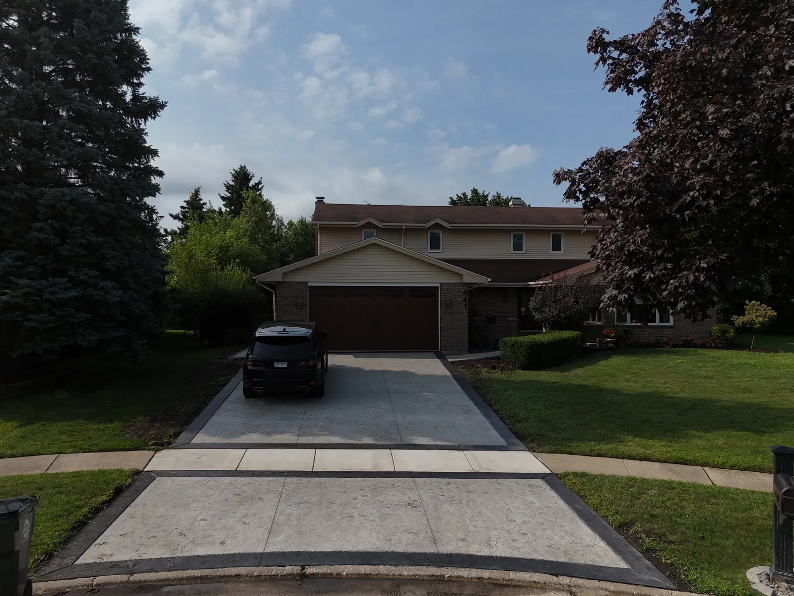 Stamped concrete driveway from street approach view