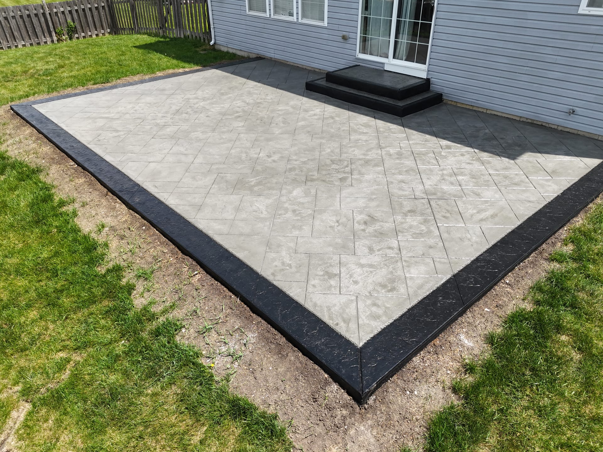 Wide aerial view of stamped concrete patio project