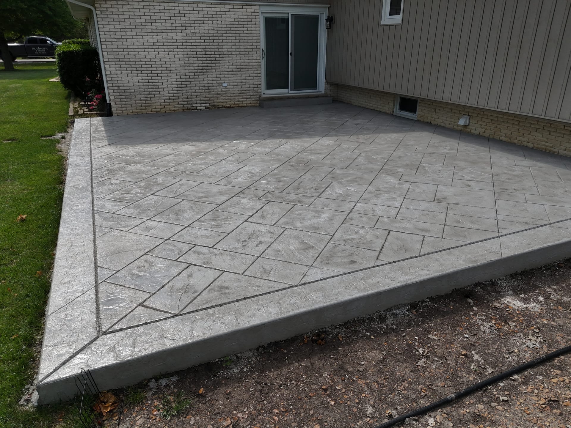 Small backyard stamped concrete patio — ZBL Concrete
