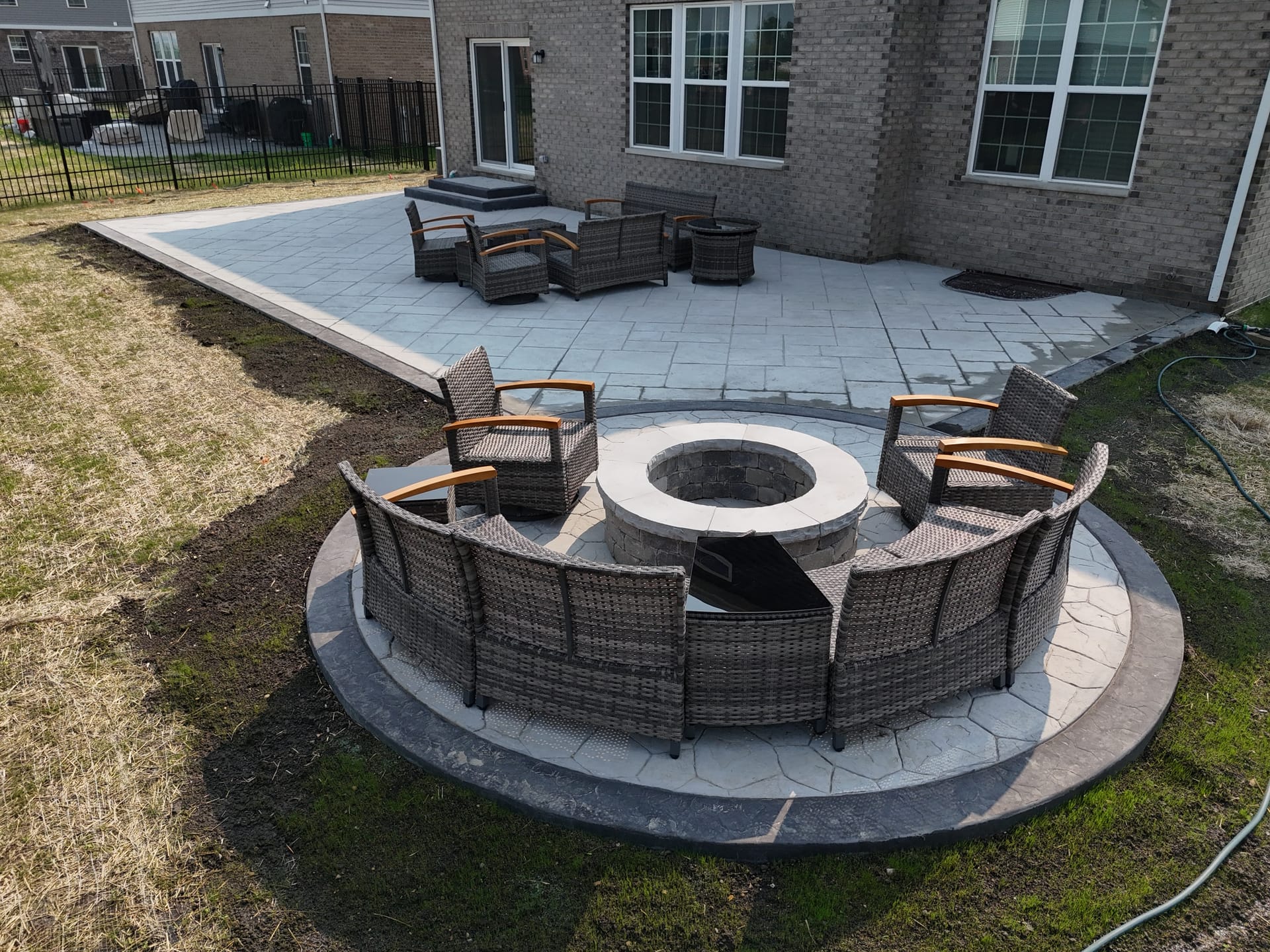 Stamped concrete patio with round fire pit in Woodridge, IL