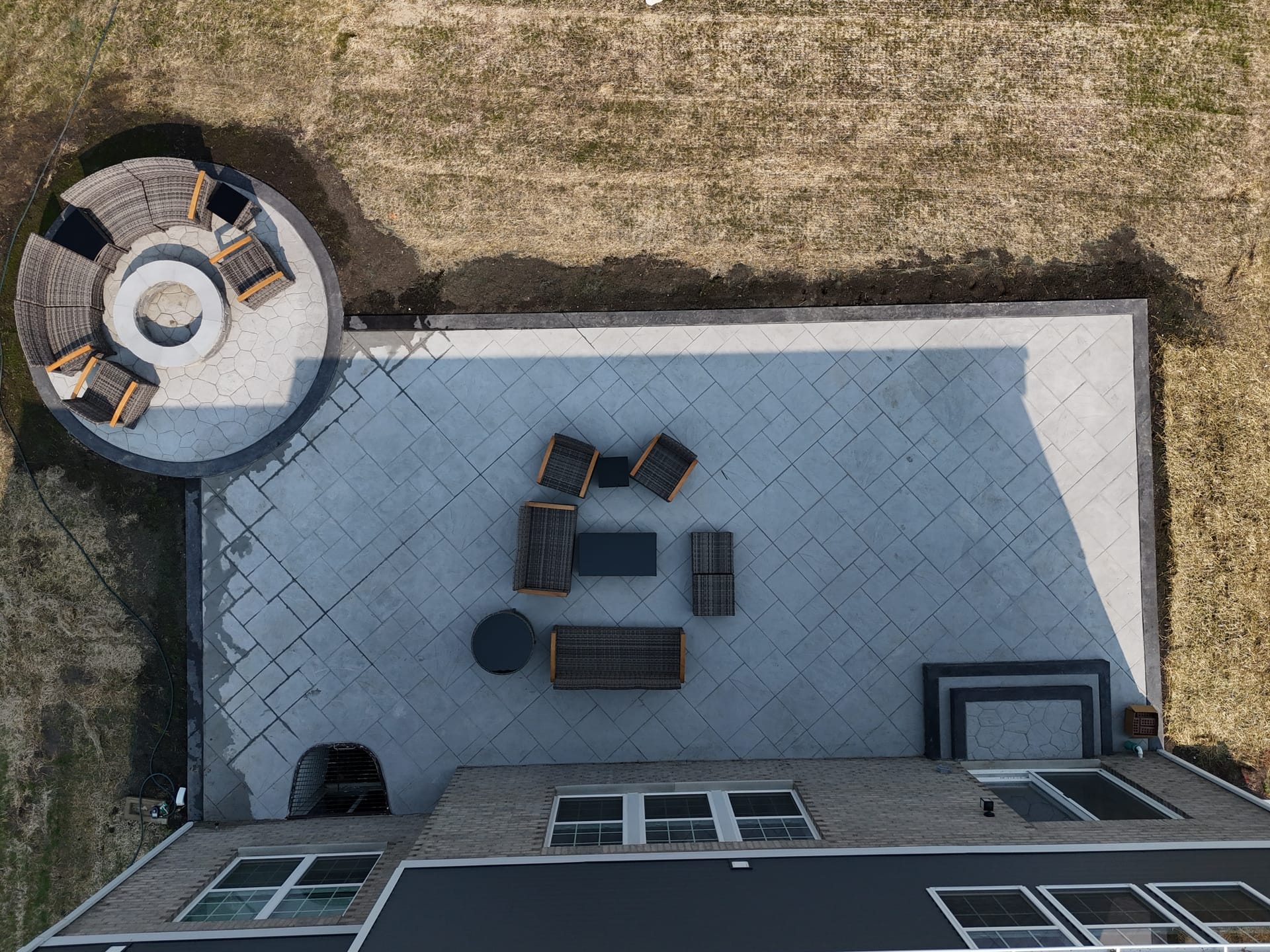 Large stamped patio with fire pit and seating area
