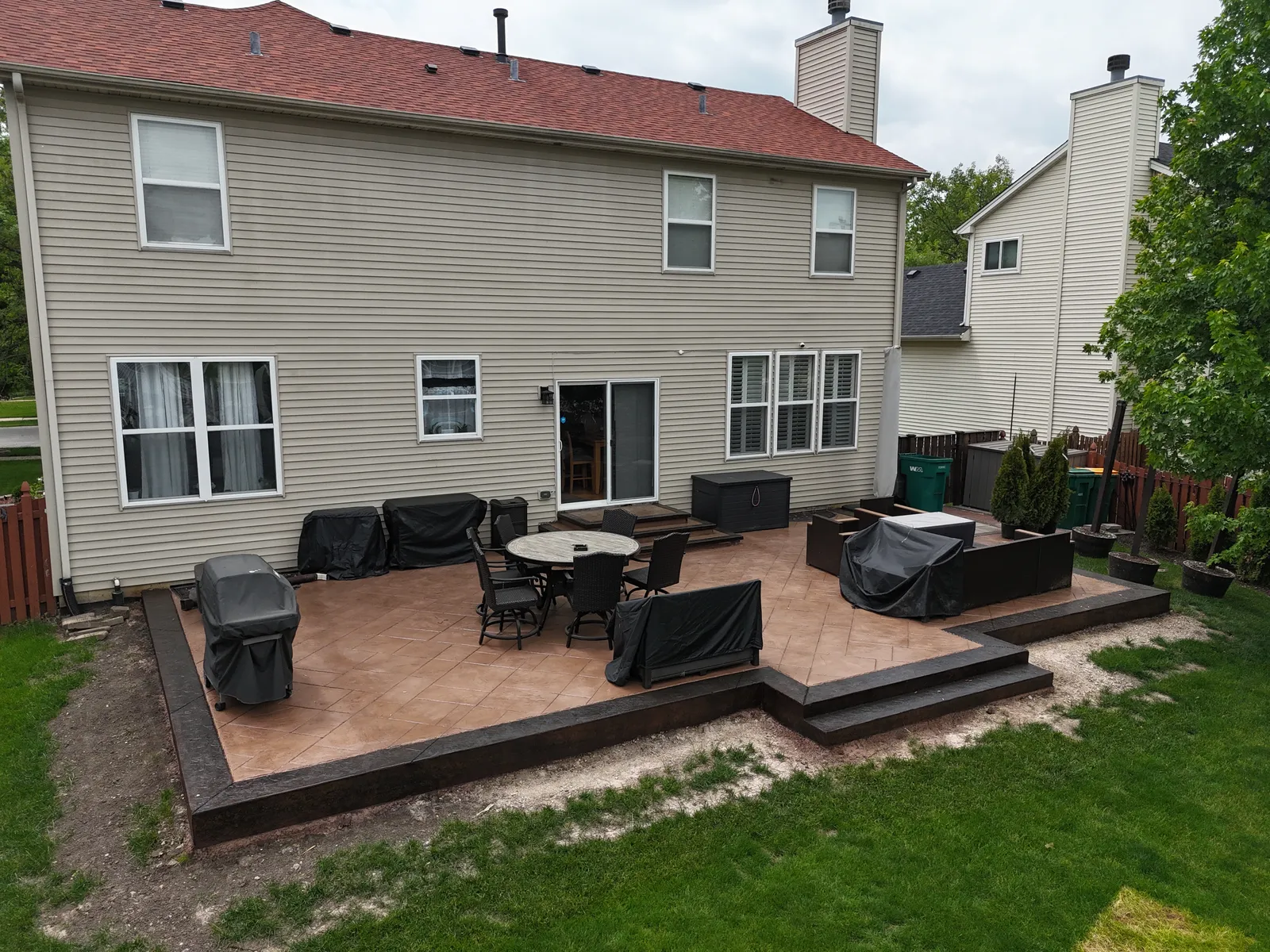 Multi-level stamped patio with dark stone steps