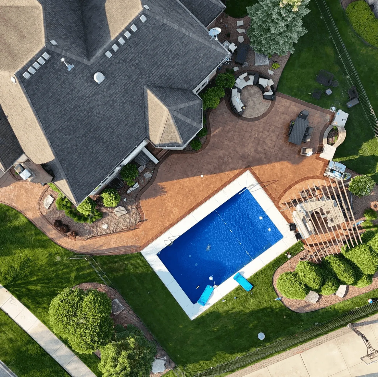 Stamped concrete pool deck and patio aerial drone view in Lockport IL by ZBL Concrete