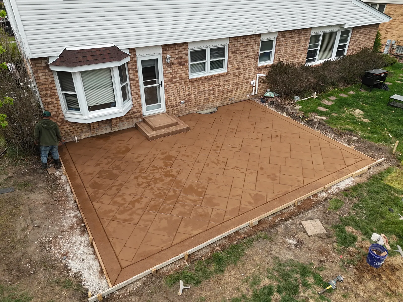 Terra cotta stamped concrete patio with brick pattern