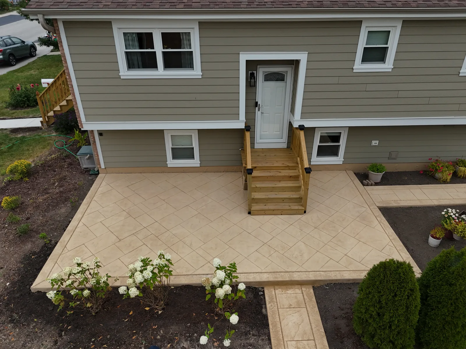 Stamped patio and walkway with white hydrangeas — curb appeal