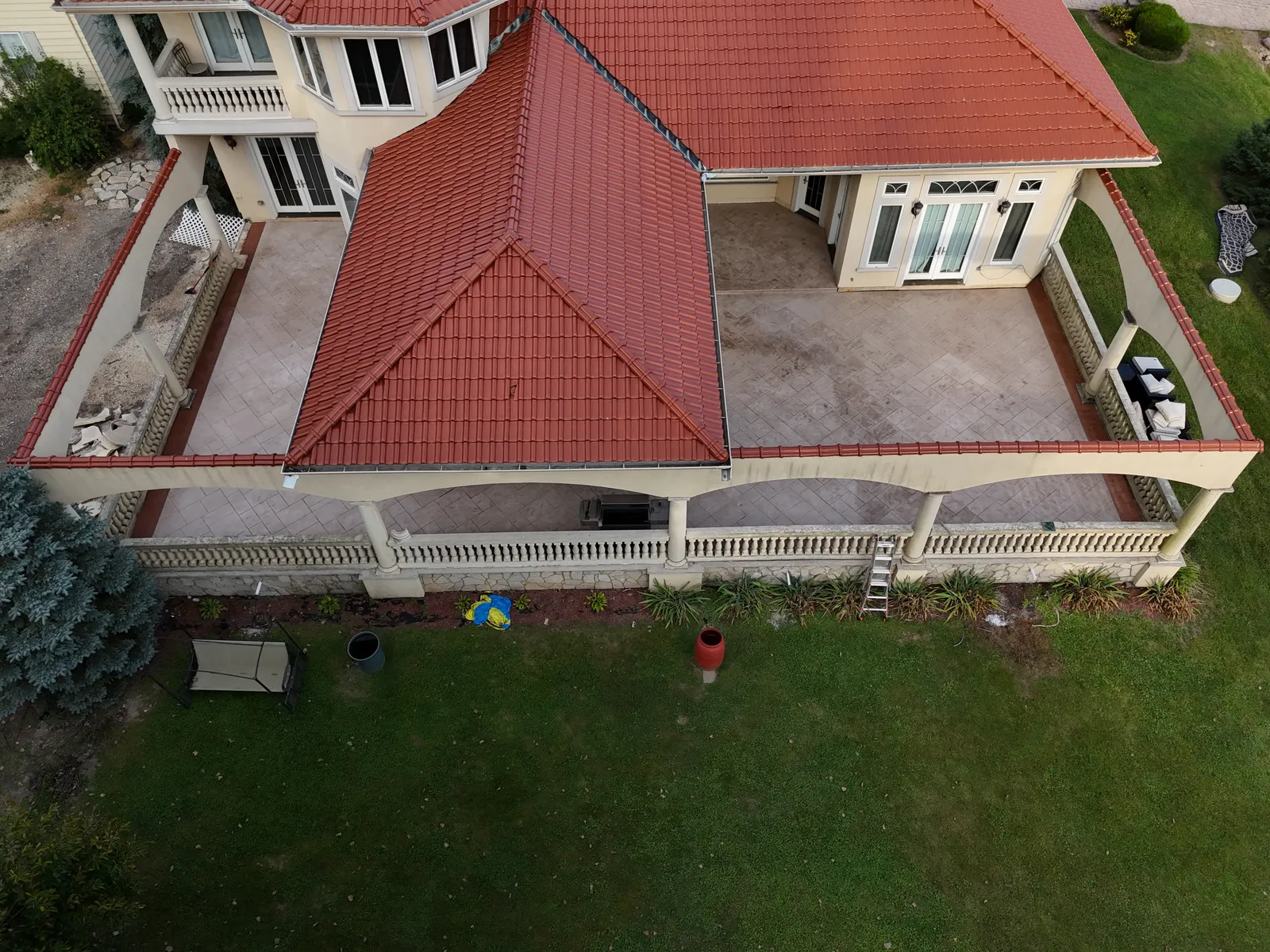 Stamped concrete veranda at Mediterranean-style home with balustrade