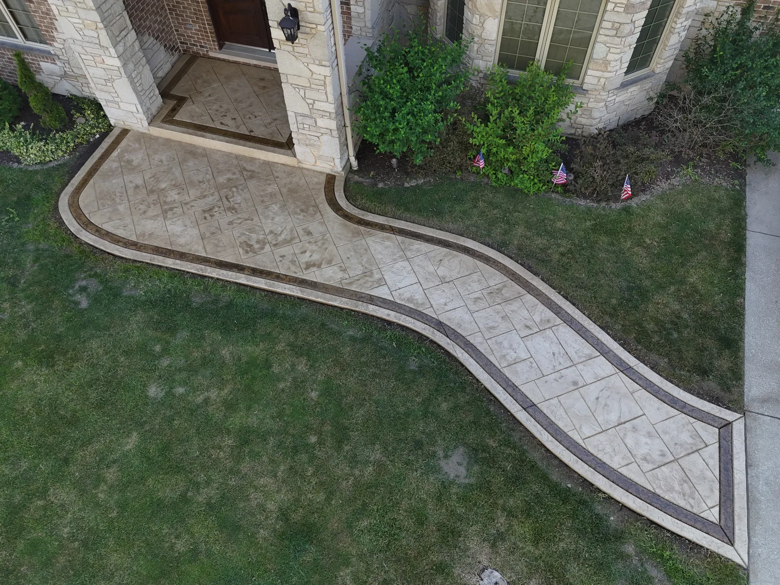 Stamped S-curve front walkway — aerial hero shot